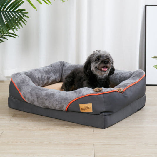 Grey orthopedic dog bed with memory foam, ideal for large dogs. Washable cover for easy care.