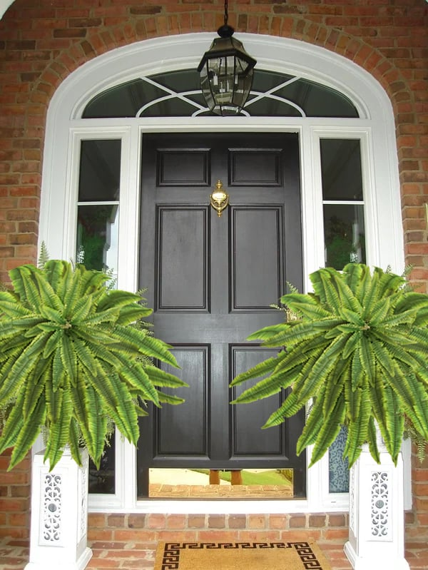 Vibrant green artificial Boston fern, ideal for maintenance-free outdoor landscaping & patio greenery.