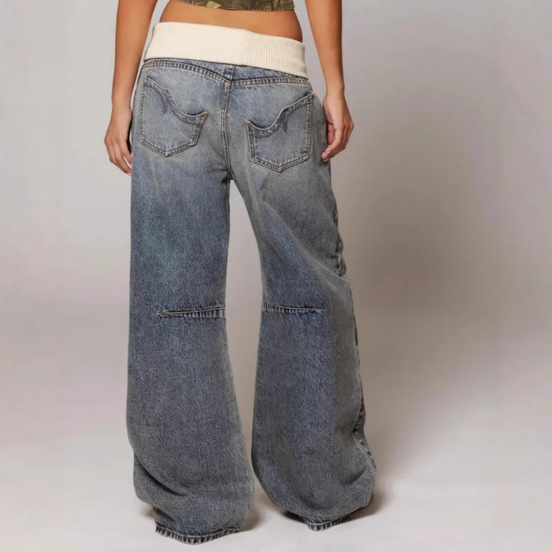 Vintage style oversized light blue women's jeans featuring a unique curved seam. Y2K fashion.