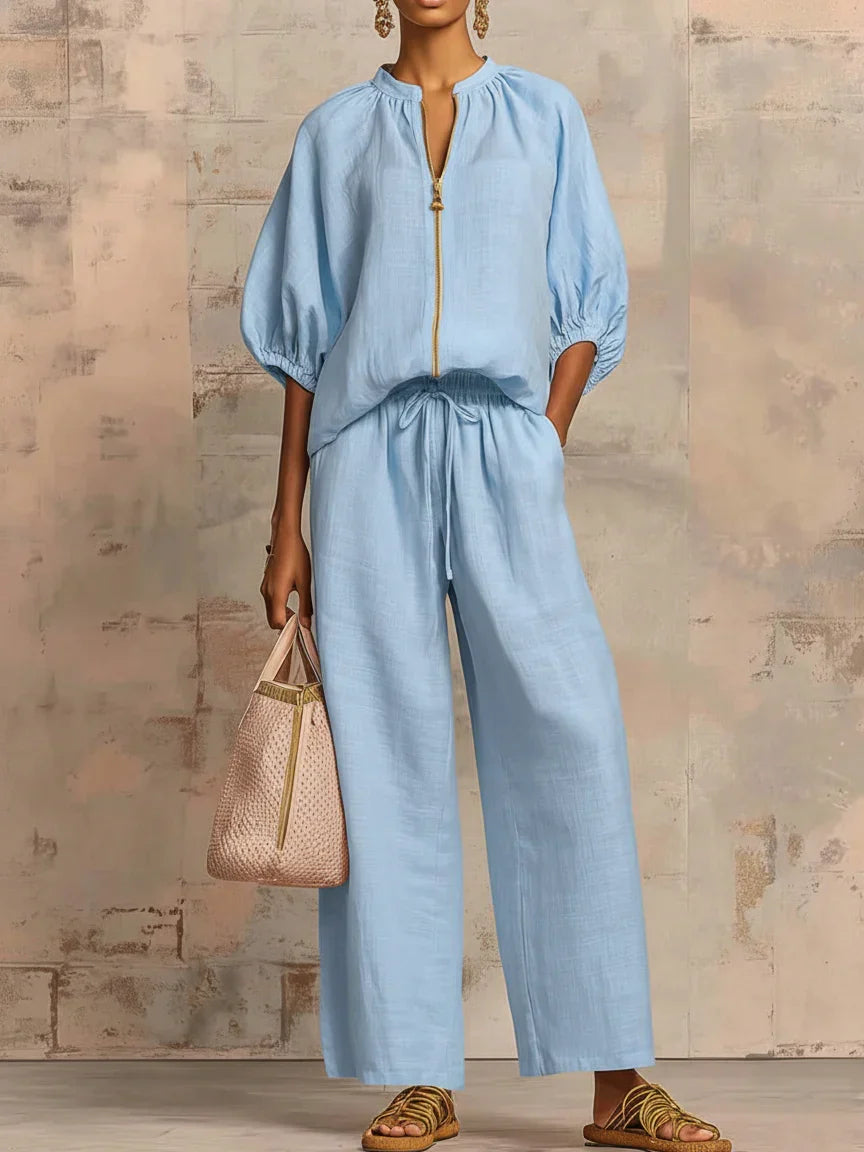 Pink women's relaxed fit button-up shirt & matching wide-leg trousers two-piece set. Stylish, comfortable fashion.