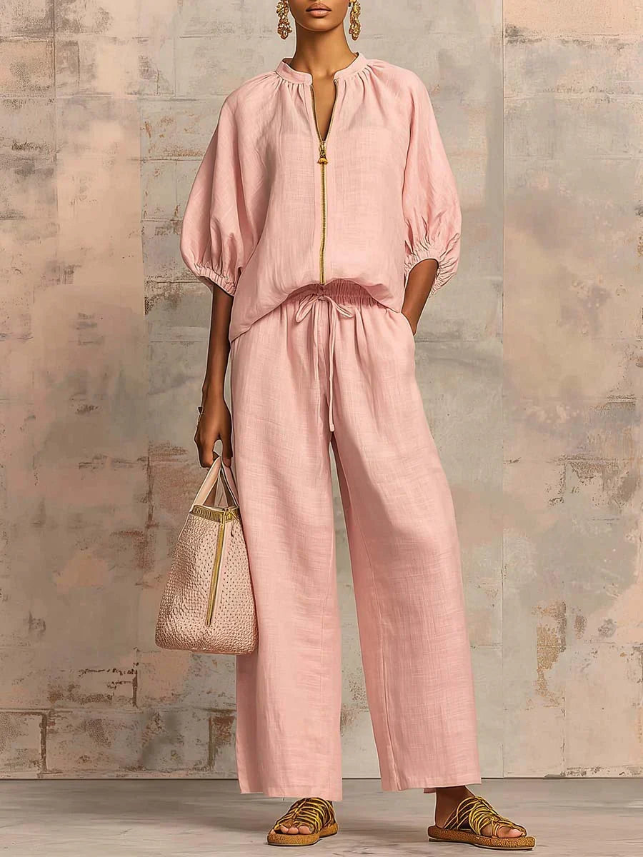 White women's two-piece set with a relaxed button-up shirt and wide-leg trousers. Elegant casual summer fashion.
