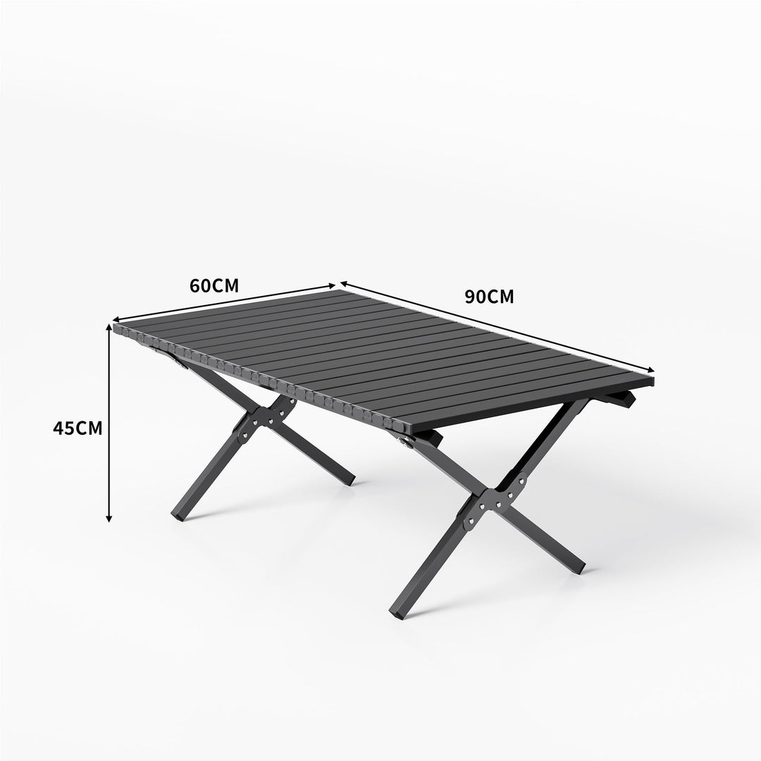 Aluminum folding table in a natural outdoor setting, perfect for camping, picnics, and backyard use.
