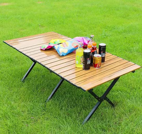 Portable outdoor table, sturdy and durable, designed for easy setup and take down during camping.