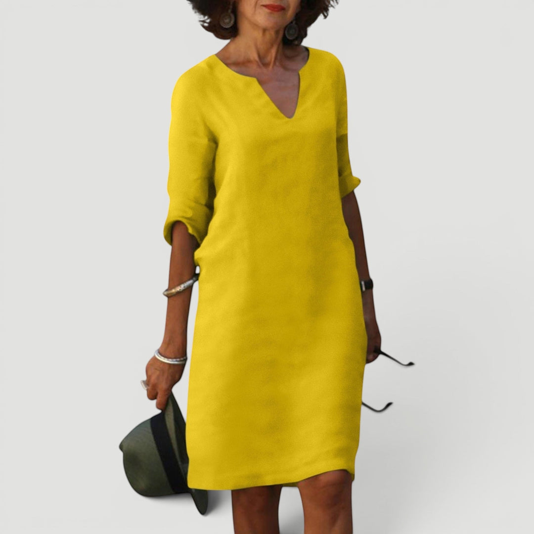 Elegant women's shift dress, V-neck, 3/4 sleeves, midi length. Lightweight and comfortable fashion.