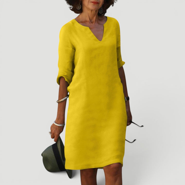 Elegant women's shift dress, V-neck, 3/4 sleeves, midi length. Lightweight and comfortable fashion.