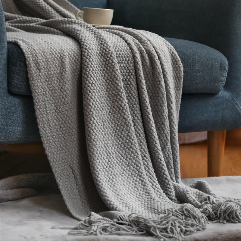 Cozy merino-style acrylic blanket featuring stylish tassels, a luxurious warm throw for your home.
