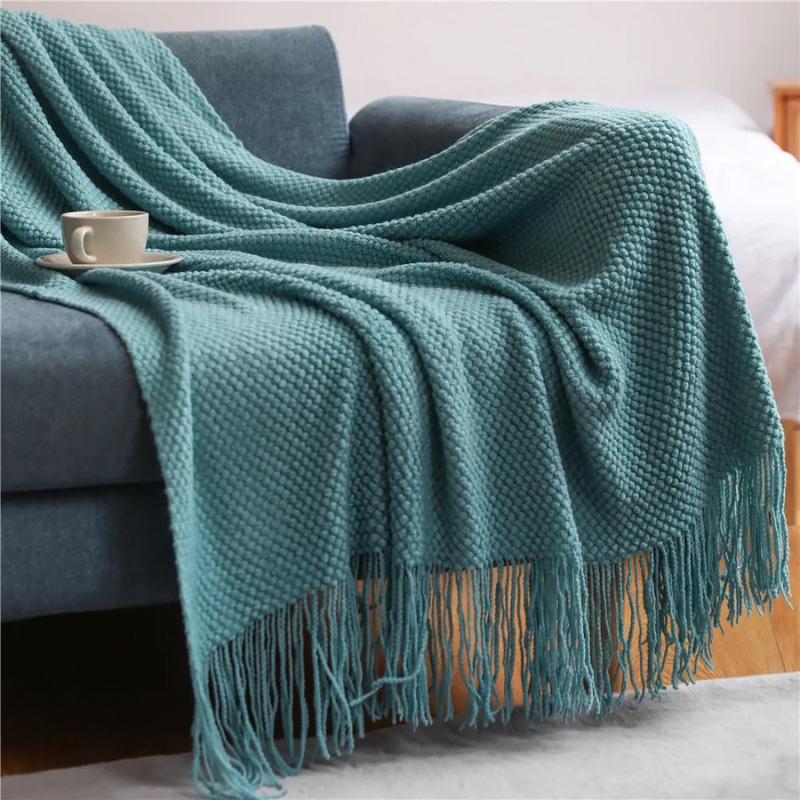 Bedroom accent: soft merino-style blanket with tassels. Warm, comfortable, and a stylish home decor throw.