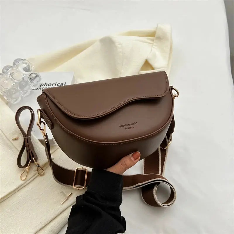 Elegant black women's shoulder bag. Stylish compact purse, a versatile fashion accessory.