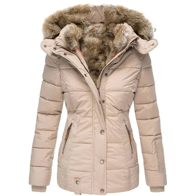 Woman models a stylish women's luxury winter puffer jacket with a cozy faux fur hood. Ideal for cold.
