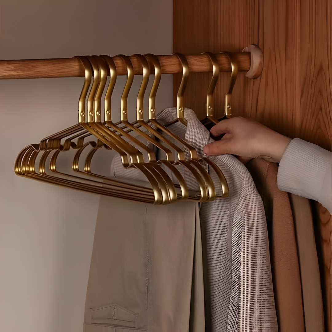 Stylish black velvet space-saving hangers with gold accents, enhancing home decor and closet organization.