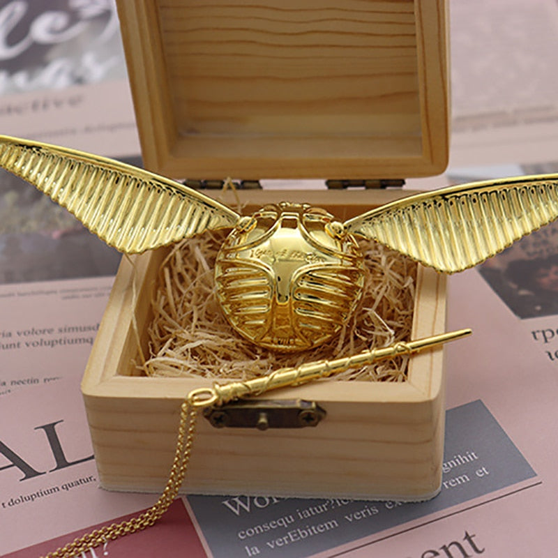 Fantasy-themed gold ring box featuring a detailed winged orb.