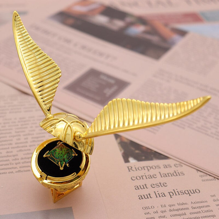Close-up of the enchanting gold plated winged orb ring box.