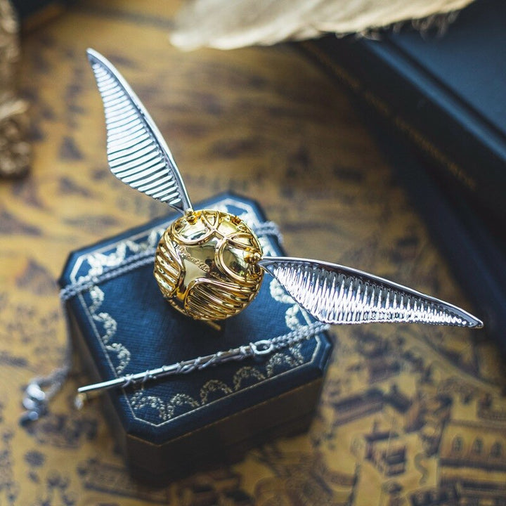Elegant gold winged orb ring box, perfect for luxury gifts.