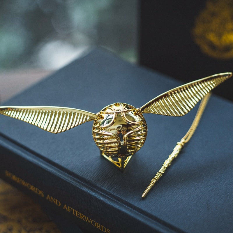 A magical gold plated jewelry case with movable orb and wings.