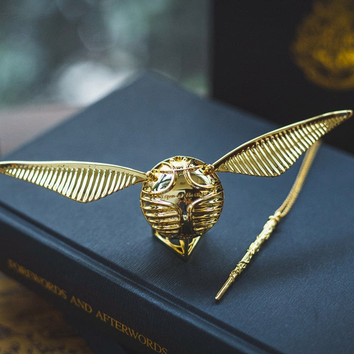 A magical gold plated jewelry case with movable orb and wings.