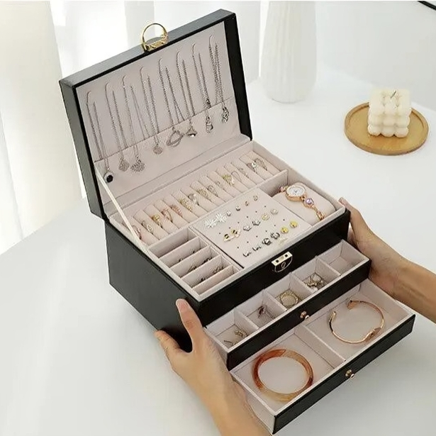 Detailed shot of luxury multi-layer jewelry organizer with spacious drawers, ideal for secure, compact storage of valuables.