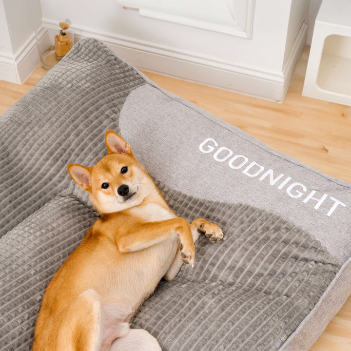 Brown orthopedic memory foam dog bed, headrest design, durable & washable cover for pets.