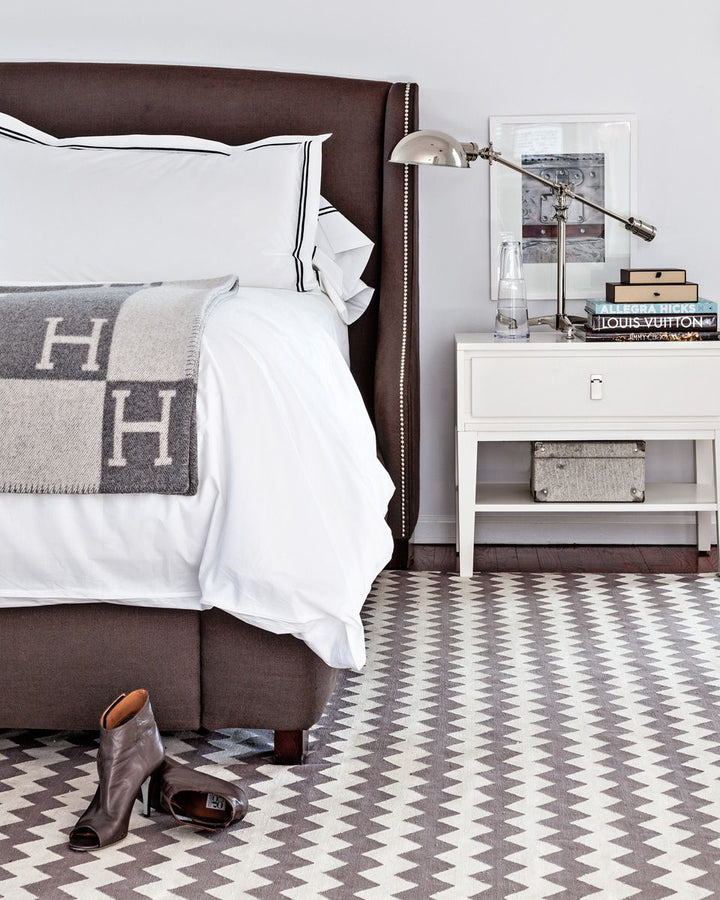 A sophisticated black wool cashmere throw blanket styled with modern home decor accessories