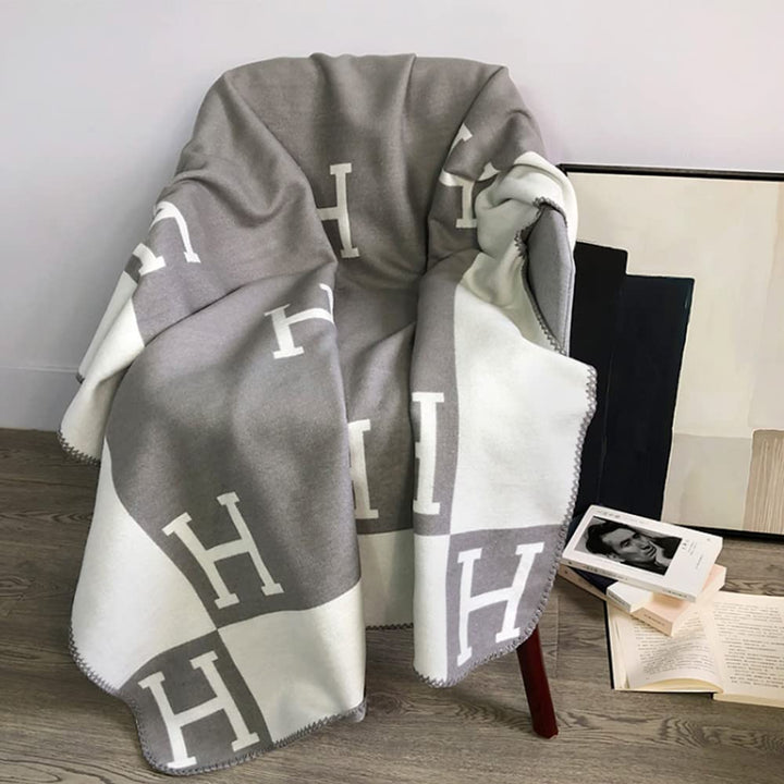 This ultra-soft wool cashmere throw blanket in a heather grey is perfect for winter warmth