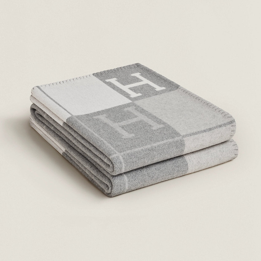 Close-up texture of a plush wool cashmere throw blanket in cream, showing fine fibers