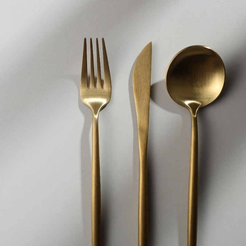 Complete matte cutlery dining set beautifully arranged on a minimalist table setting.