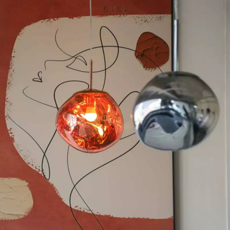 Melt pendant lamp used as a statement piece over a dining table, enhancing interior design.