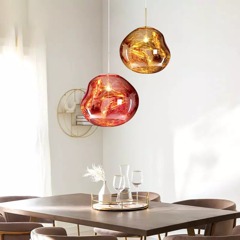 Melt pendant lamp in a gold finish, casting a warm, inviting glow in a modern living space.