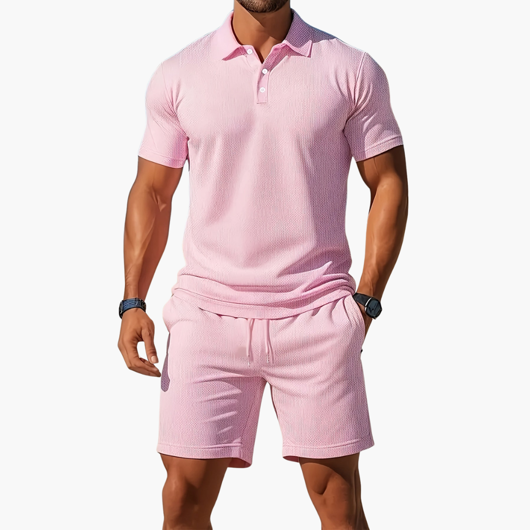 Full body shot of a man in a summer athletic polo shirt and shorts ensemble.