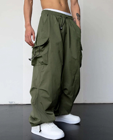 Man in comfortable men's baggy wide leg cargo pants, showcasing modern casual street style.