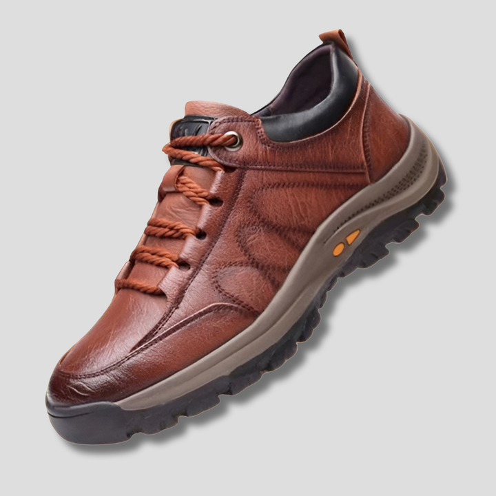 Men's Balance brown leather slip-on shoes showing a close-up of the stitching and water-resistant features.