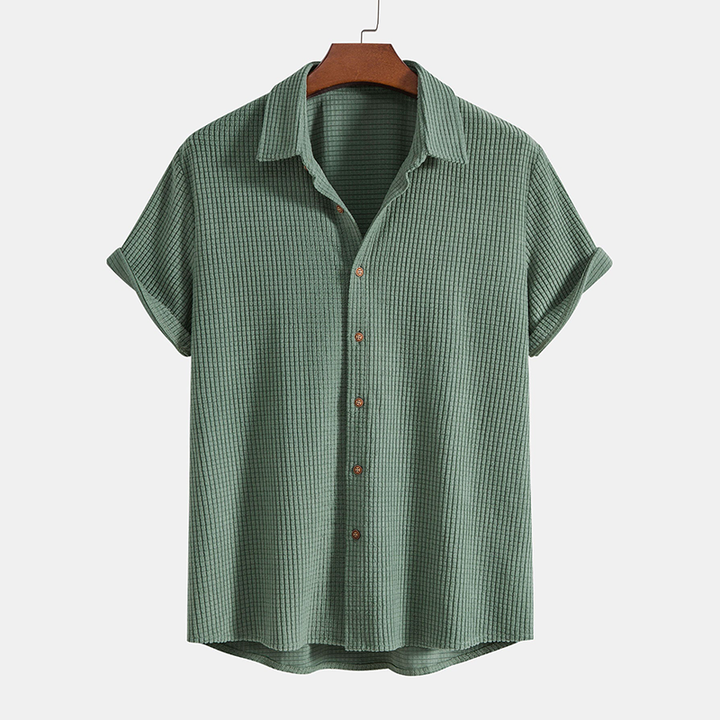 Men's beige short sleeve button-up shirt and matching casual shorts for summer fashion.