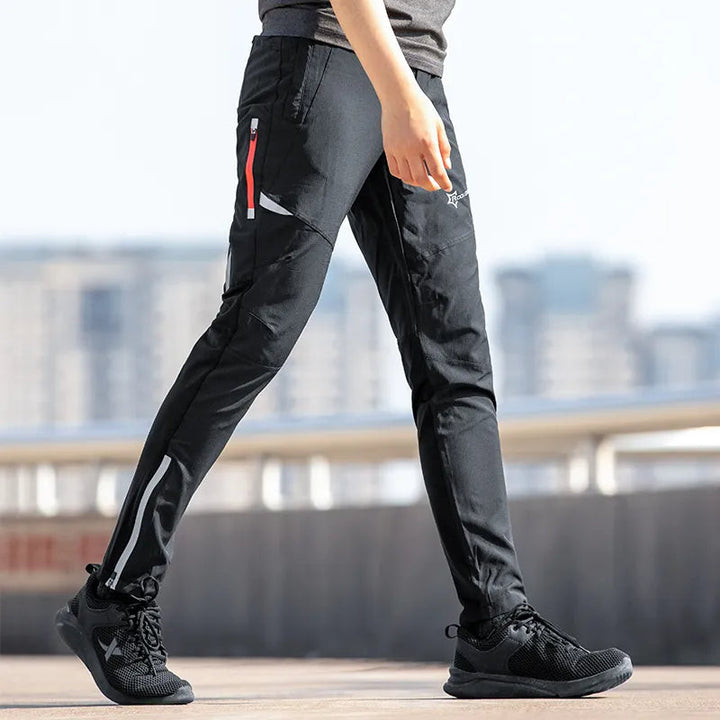 Men's black breathable stretch cycling trousers with reflective details for safe night riding.