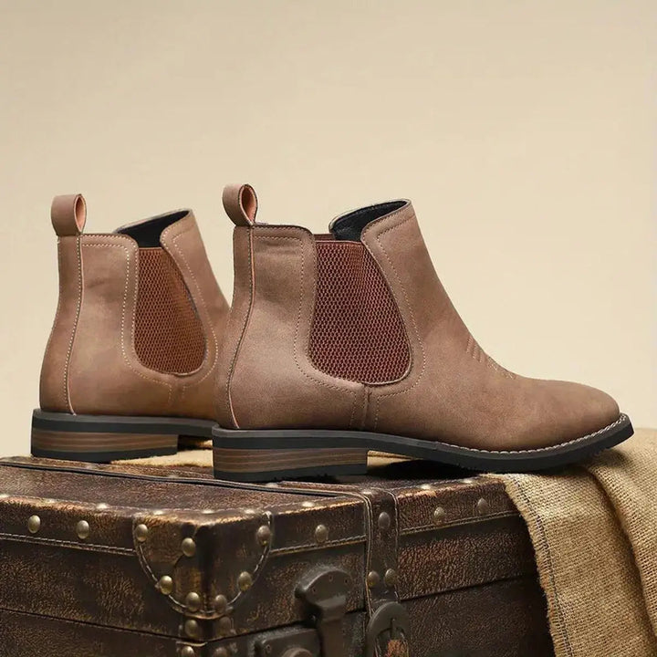 Versatile men's black Chelsea boots, slip-on design, with subtle yet stylish western stitching.