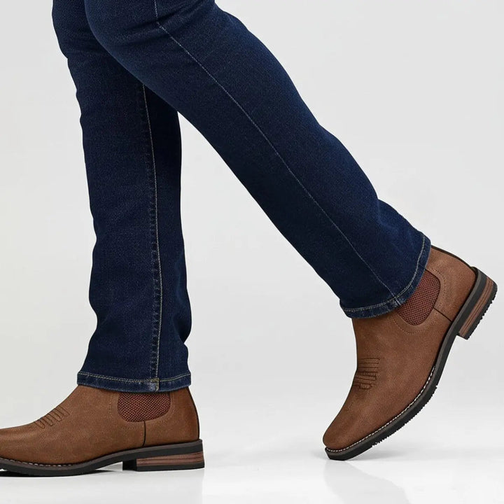 Smart casual men's ankle boots: black Chelsea style with subtle western stitch detail, easy pull-on.