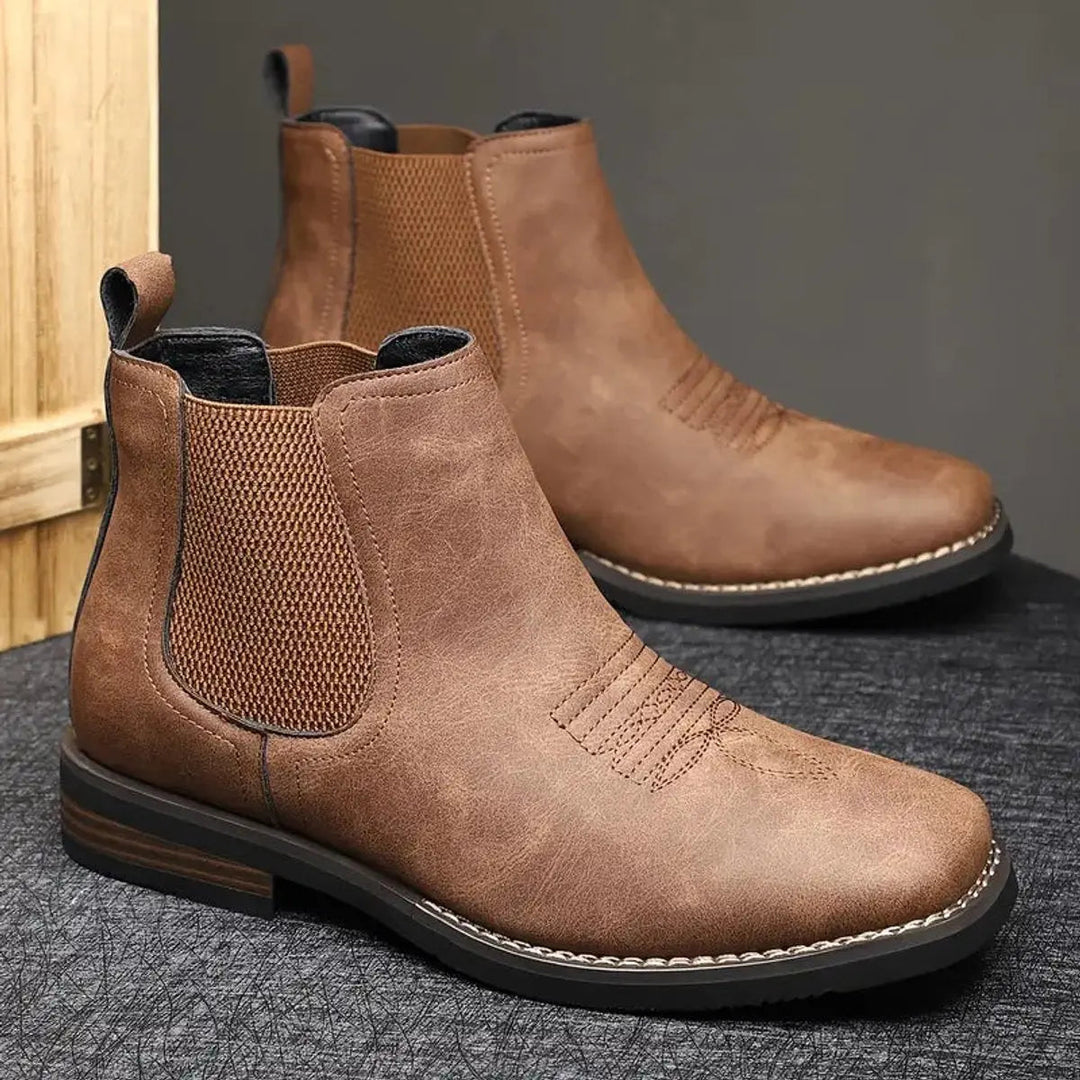 Black men's dress boots, Chelsea silhouette, featuring elegant western stitching for a refined look.