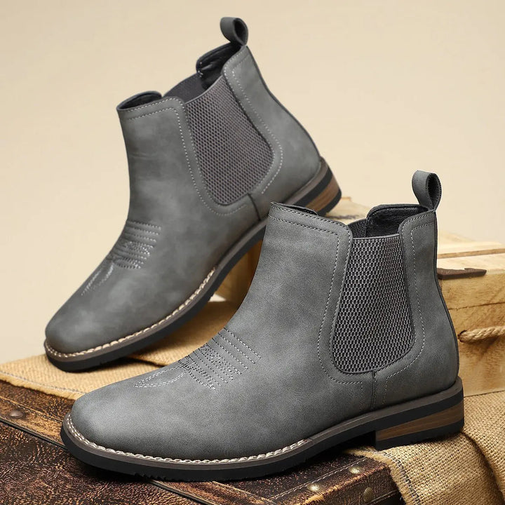 Sophisticated black Chelsea ankle boots for men, with distinctive western-inspired decorative stitching.