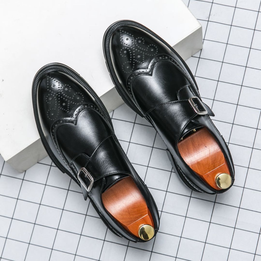Men's black leather monk strap wingtip brogue dress shoes for formal business style.