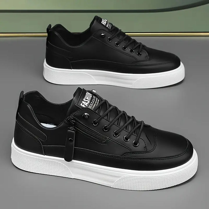 Smart casual black leather trainers with side zip detail.