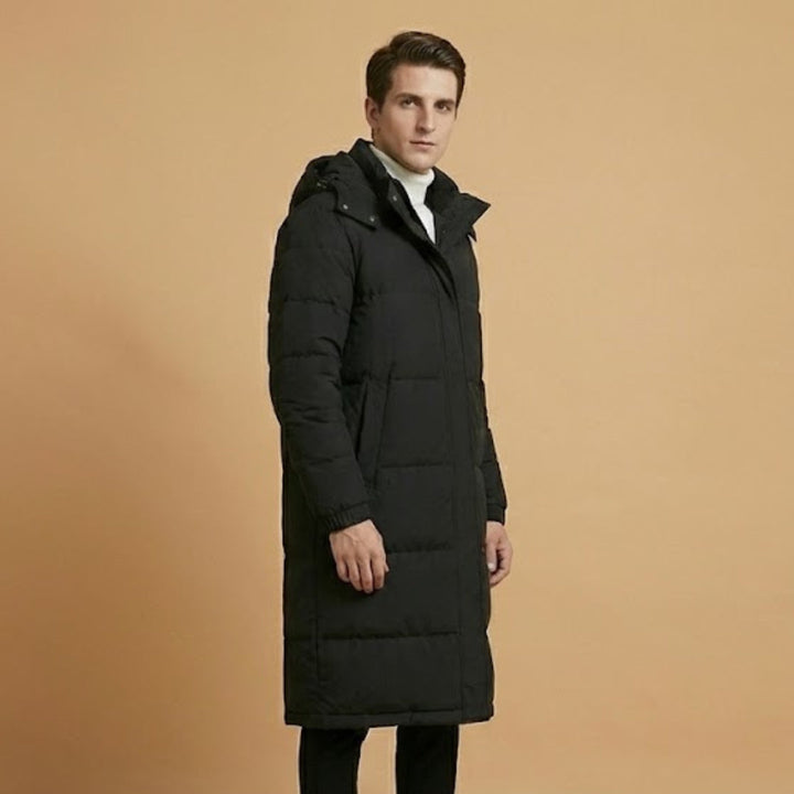 Durable men's quilted long jacket for winter. Hooded design and warm insulation perfect for cold weather fashion.