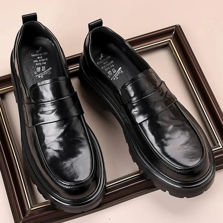 Stylish men's black slip-on penny loafers with moc toe design. Versatile formal & smart casual footwear.