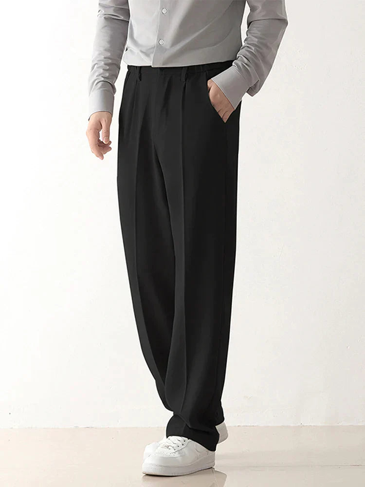 Men's relaxed fit draped black tailored trousers, comfortable and stylish for business casual fashion.