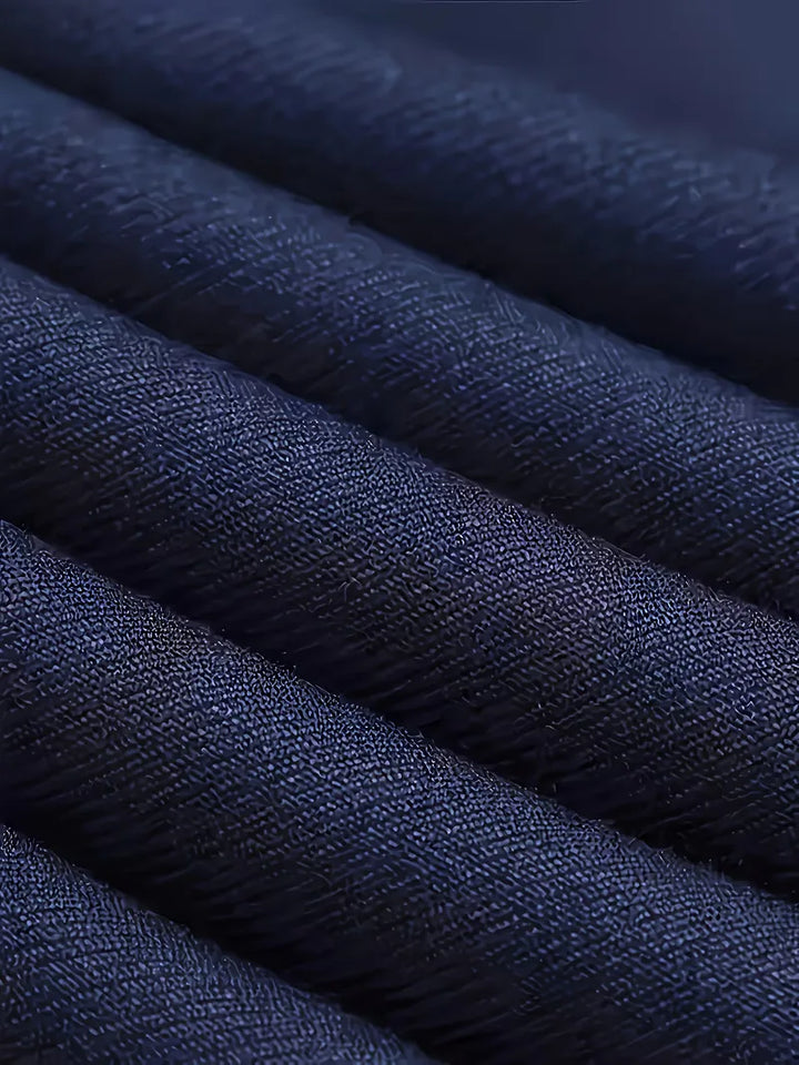 Man posing in an elegant grey slim fit three-piece suit for a special event.