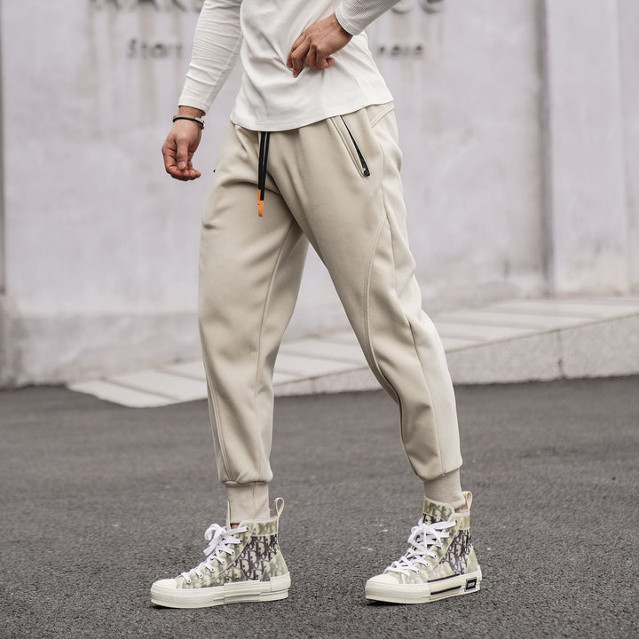 Men's black sporty jogger pants with white side stripes & elastic waistband for gym & casual wear.