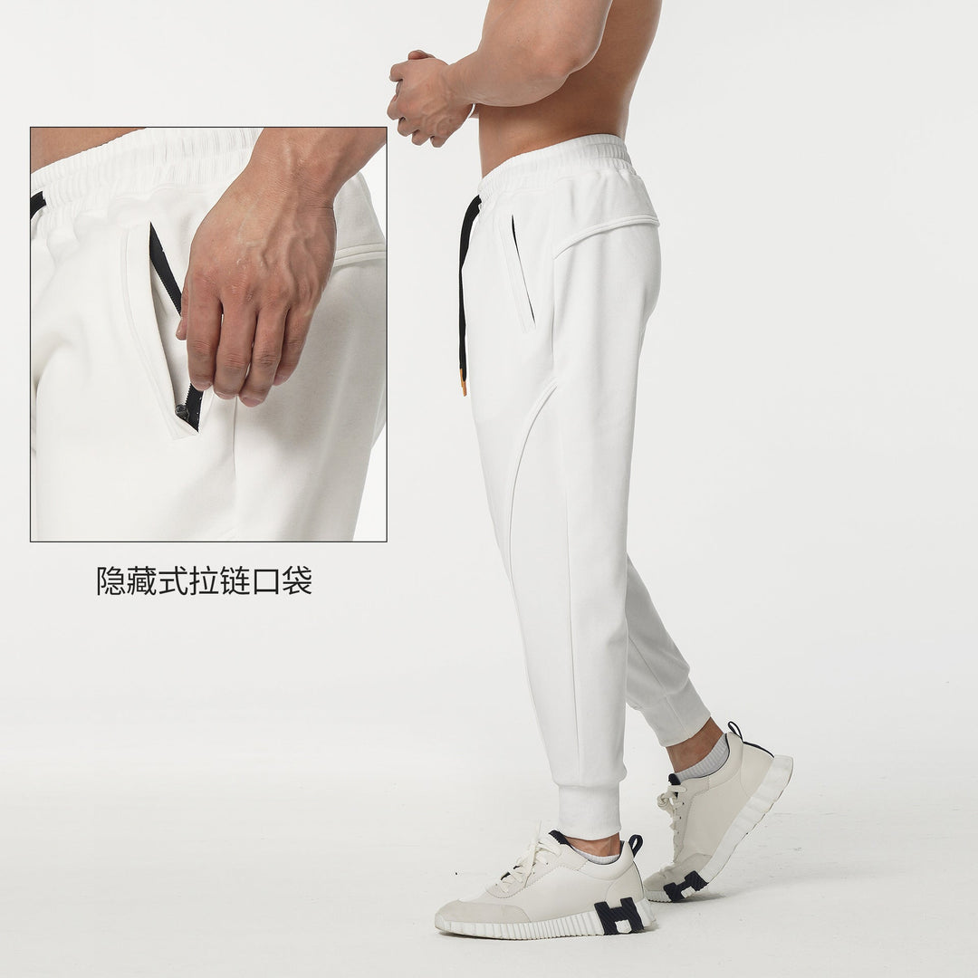 Comfortable men's athletic track pants with elastic waist and stylish side stripes, ideal for training.
