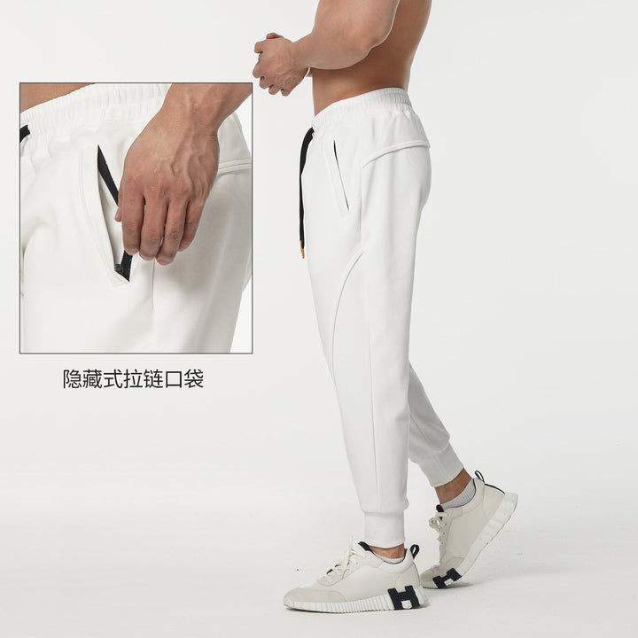 Comfortable men's athletic track pants with elastic waist and stylish side stripes, ideal for training.