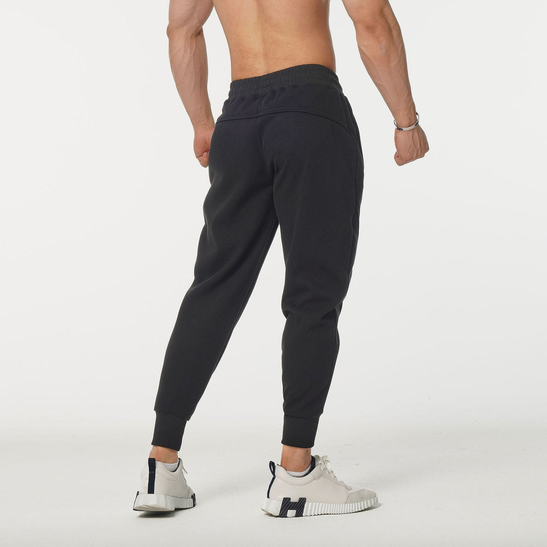 Stylish men's performance joggers in navy with side stripes & elastic waist, great for sport & streetwear.