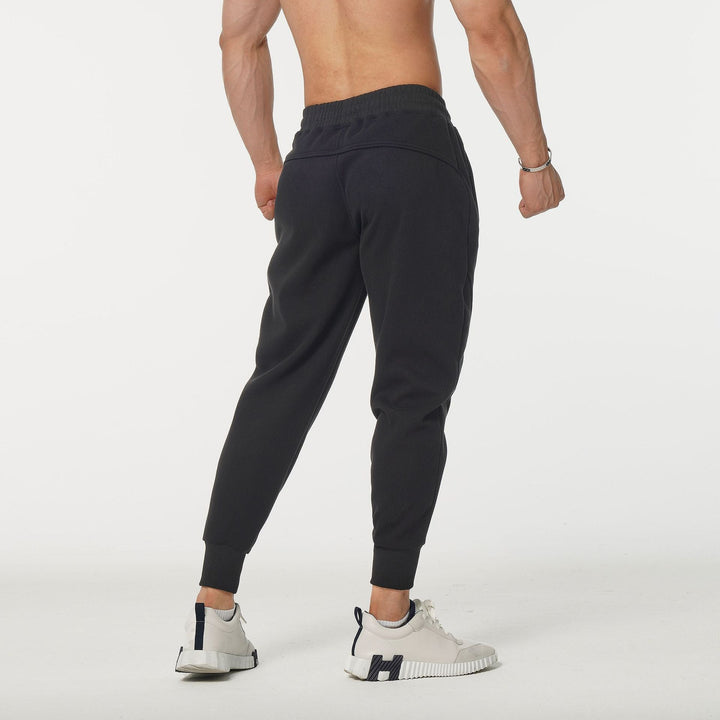 Stylish men's performance joggers in navy with side stripes & elastic waist, great for sport & streetwear.