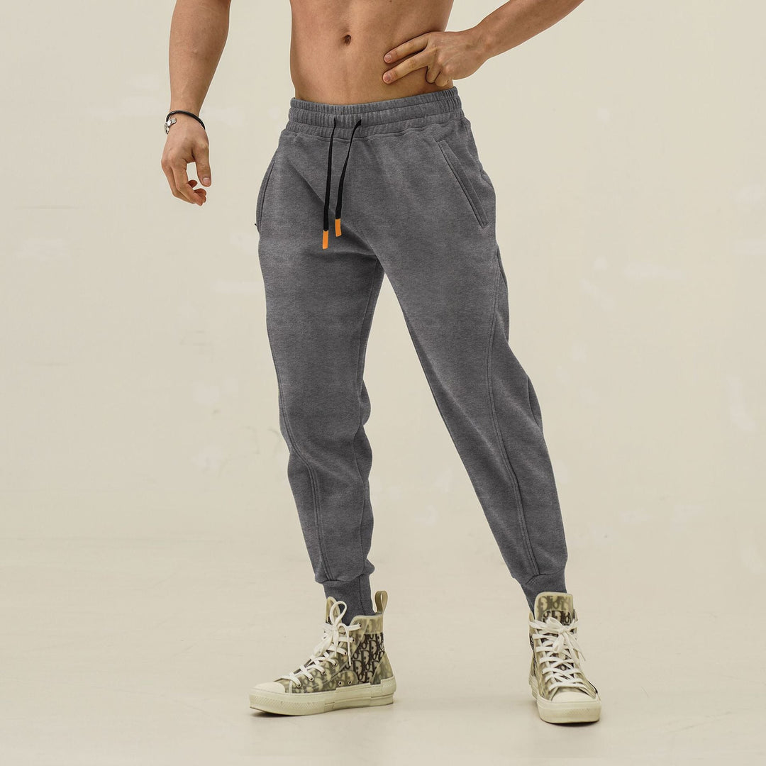 Men's trendy athletic jogger pants with elastic waistband and contrasting side stripes for performance.