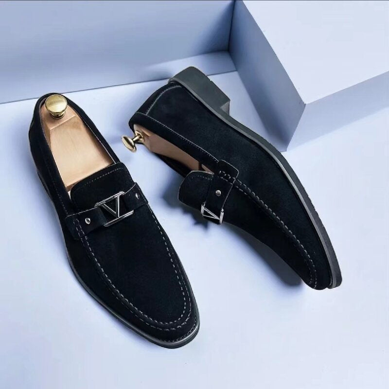 Close-up of men's black formal slip-on loafers showcasing metal bit accent