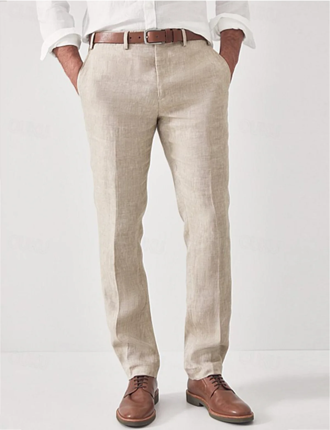 Model wearing modern fit linen trousers for men, styled for a relaxed summer look.